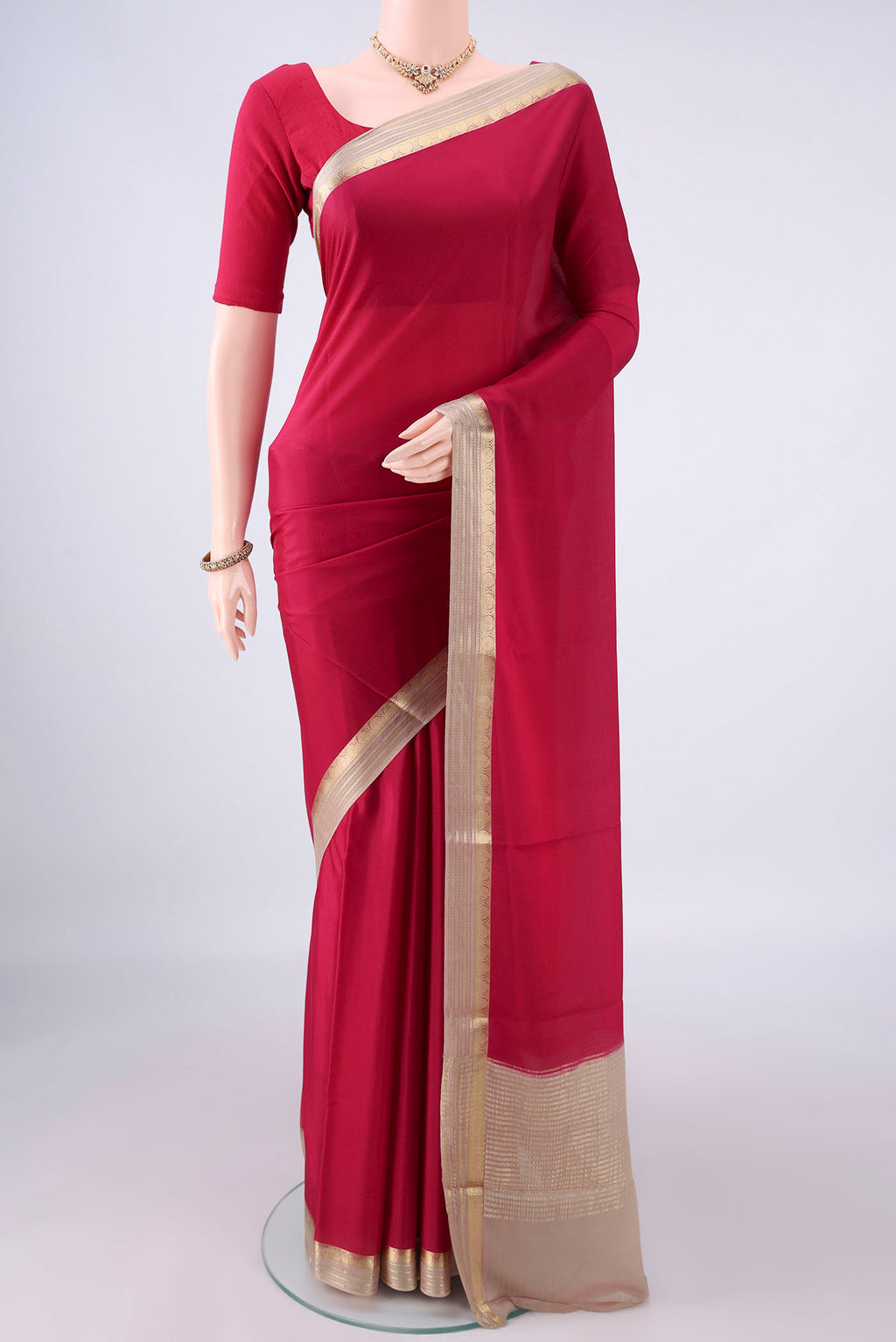 Deep Red Mysore Crepe Saree with Plain Body and Zari Border.  displayed on a mannequin
