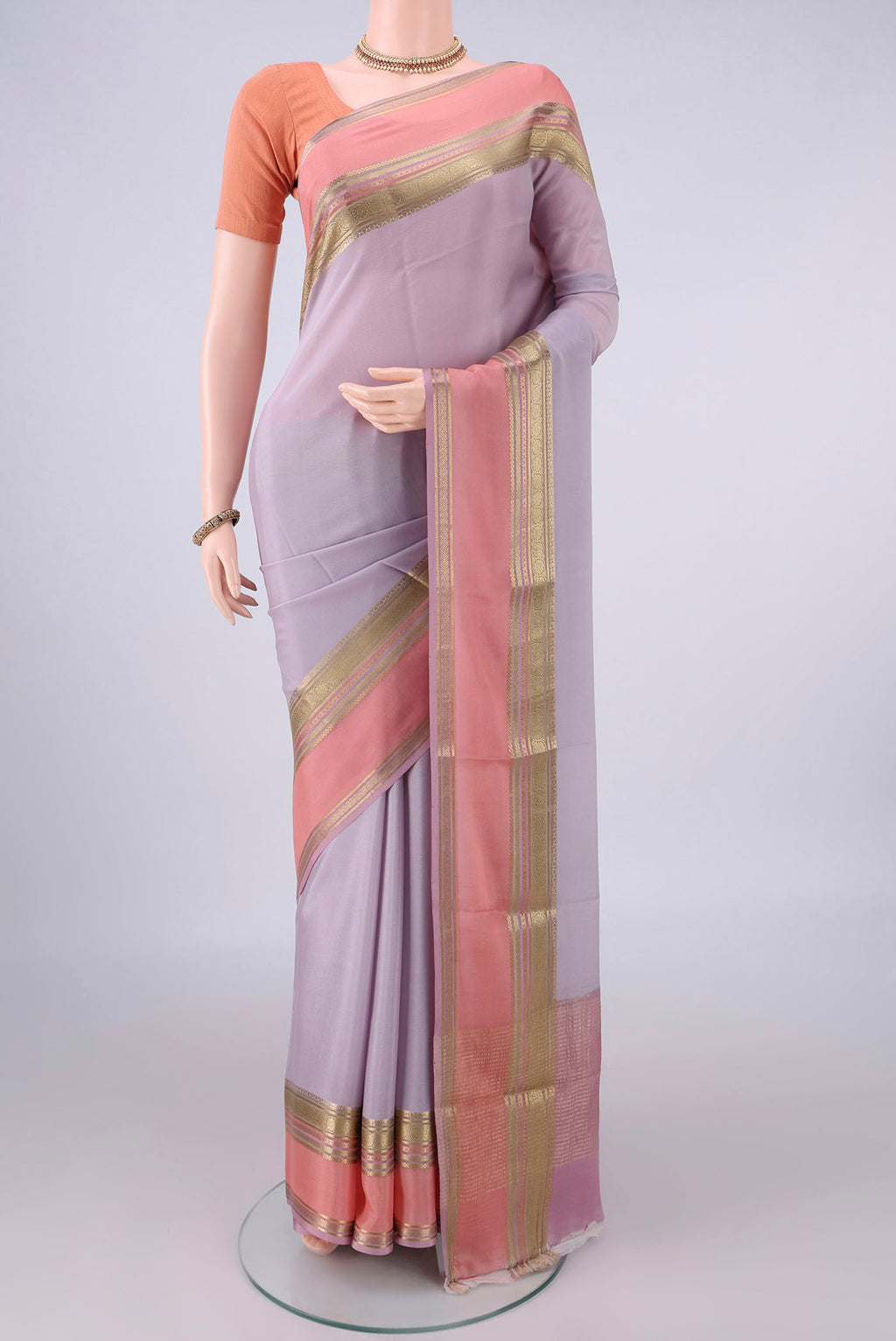 Lilac Mysore Crepe Saree with Plain Body and Zari Border.  displayed on a mannequin