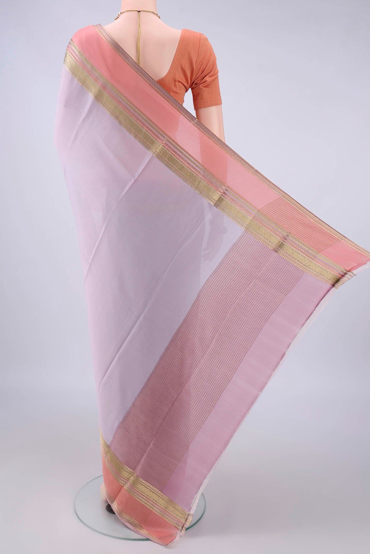Flat view of Lilac Mysore Crepe Saree with Plain Body and Zari Border. 