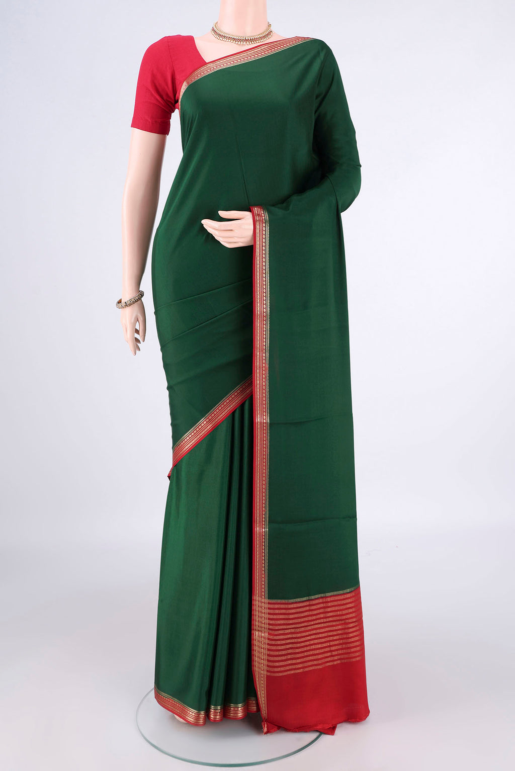 Bottle Green Mysore Crepe Saree with Plain Body and Zari Border.  displayed on a mannequin