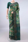 Green Tussar Saree with Printed design on the body and Zari Border.  displayed on a mannequin