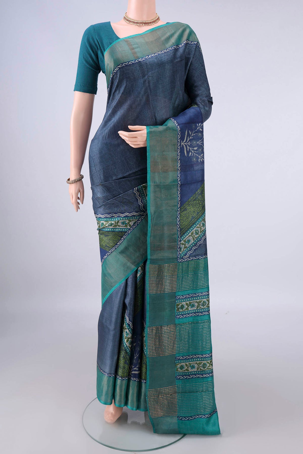 Davys Grey Tussar Saree with Printed design on the body and Zari Border.  displayed on a mannequin