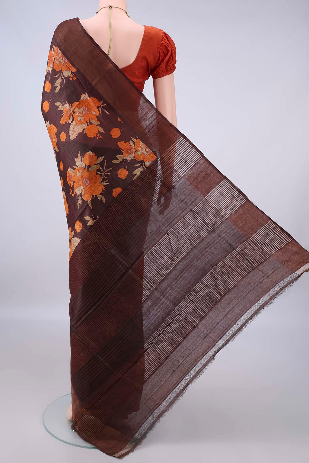 Flat view of Brown Tussar Saree with Floral Print on the body and Zari Border. 