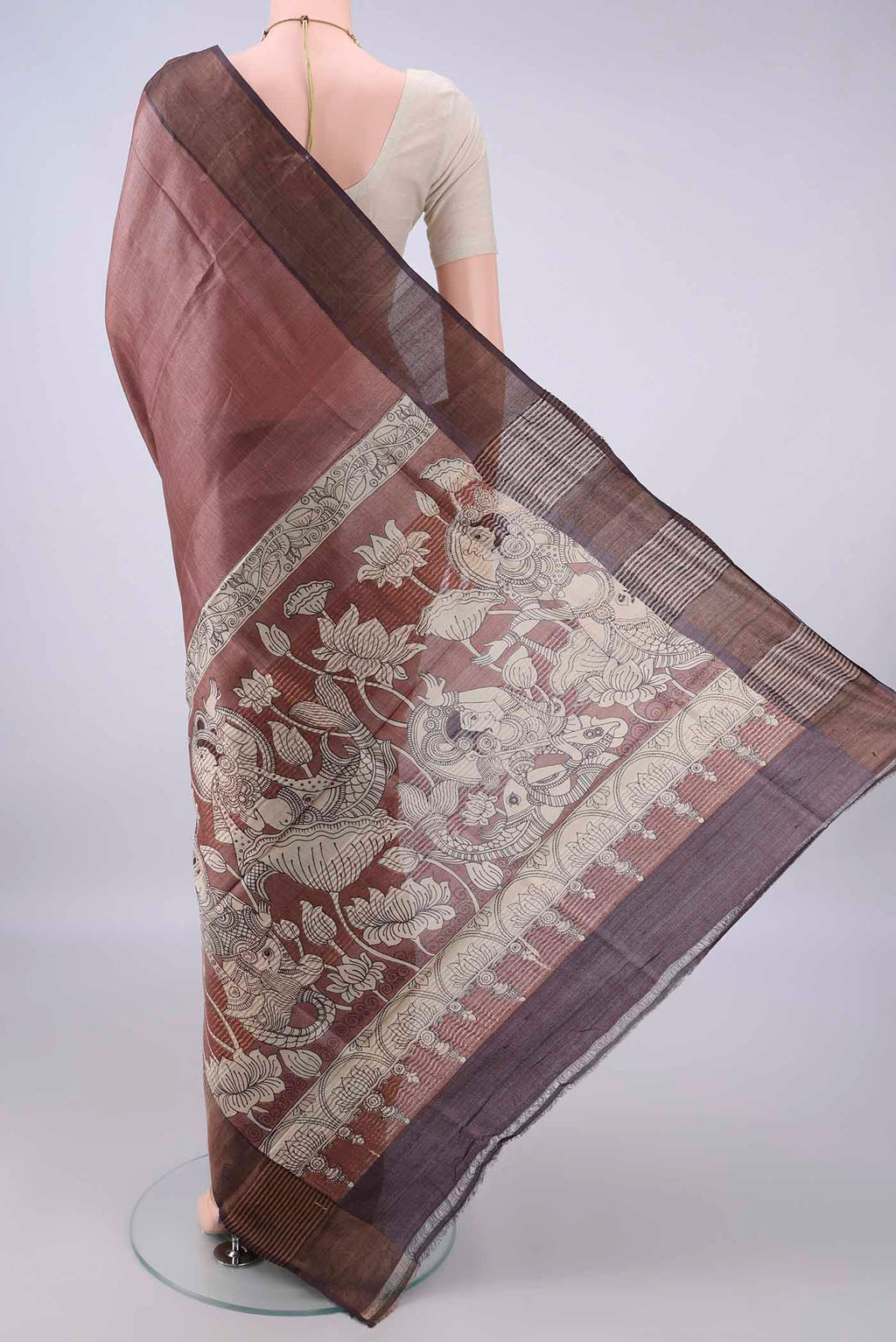 Flat view of Brown Tussar Saree with Printed design on the body and Zari Border. 
