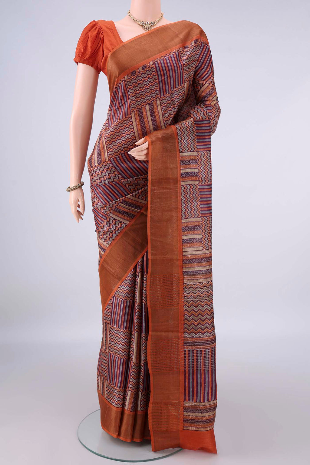 Multi Color Tussar Saree with Printed design on the body and Zari Border.  displayed on a mannequin
