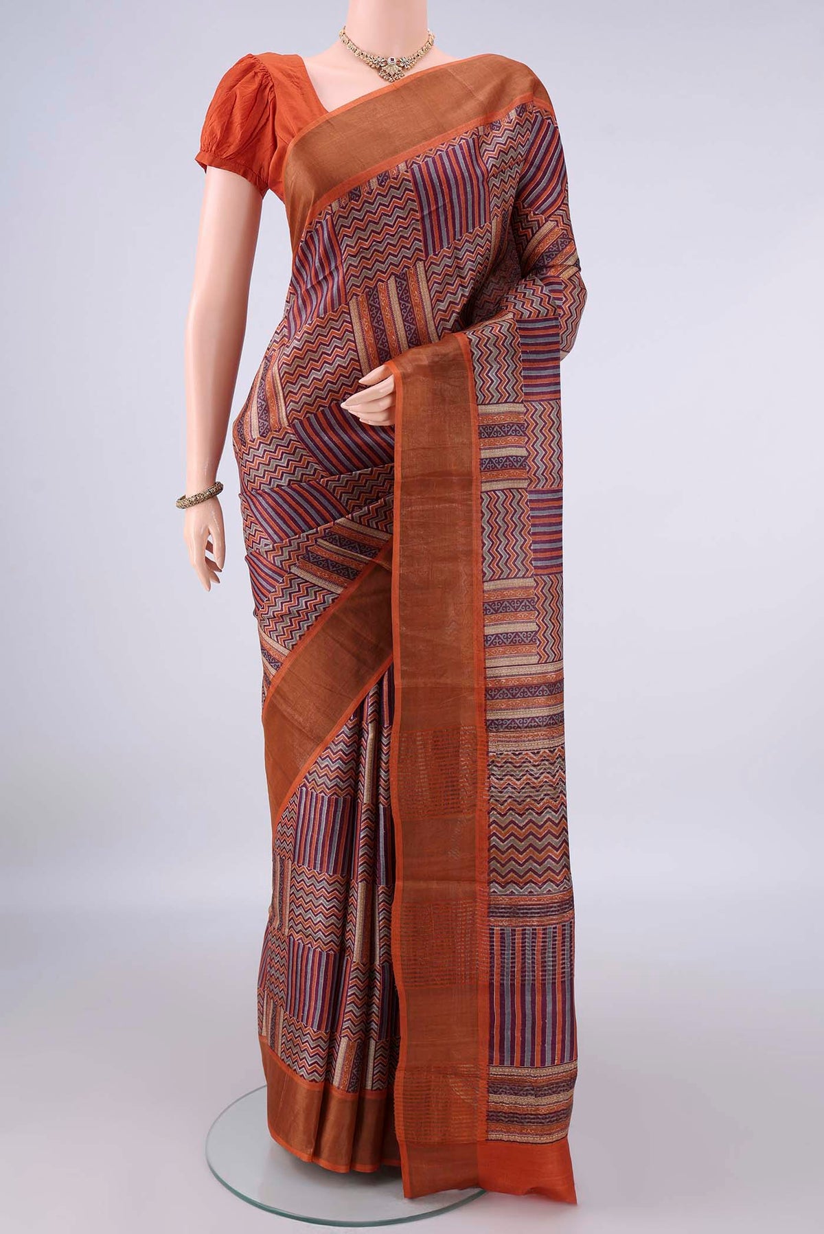 Multi Color Tussar Saree with Printed design on the body and Zari Border.  displayed on a mannequin