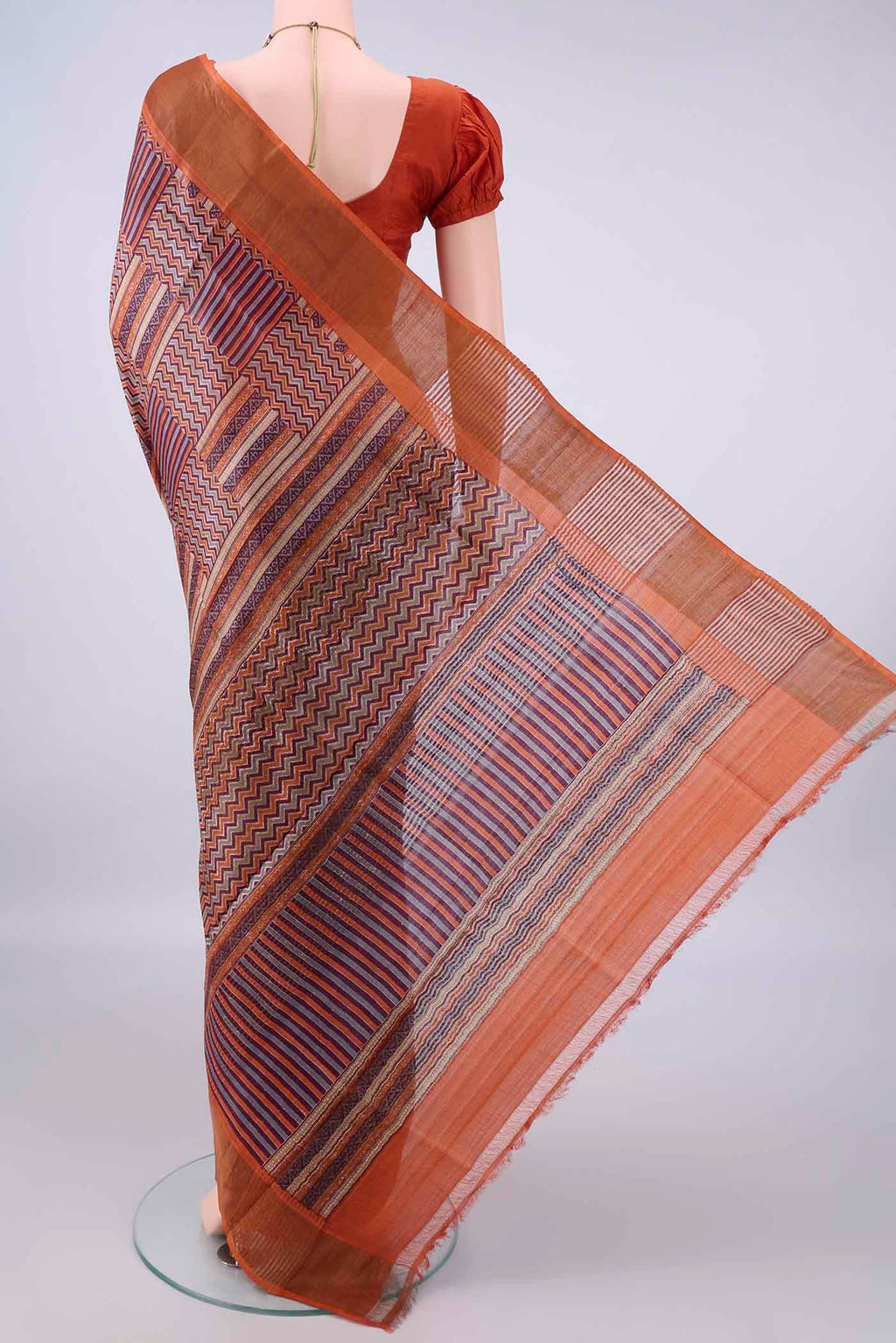 Flat view of Multi Color Tussar Saree with Printed design on the body and Zari Border. 