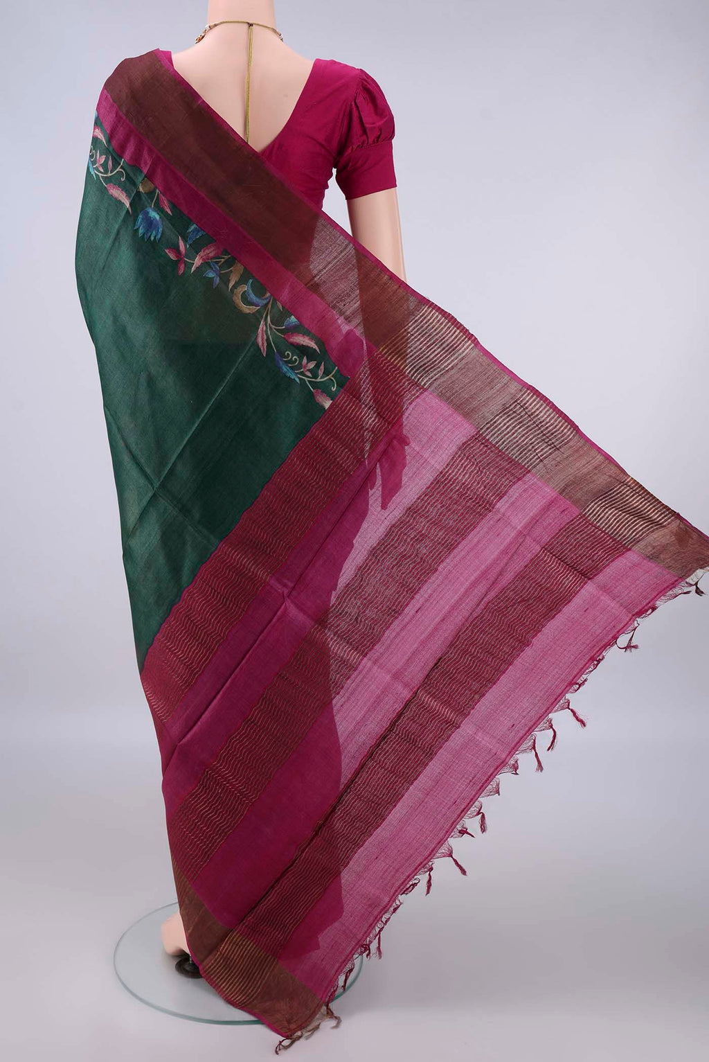 Flat view of Bottle Green Tussar Saree with Printed design on the body and Zari Border. 