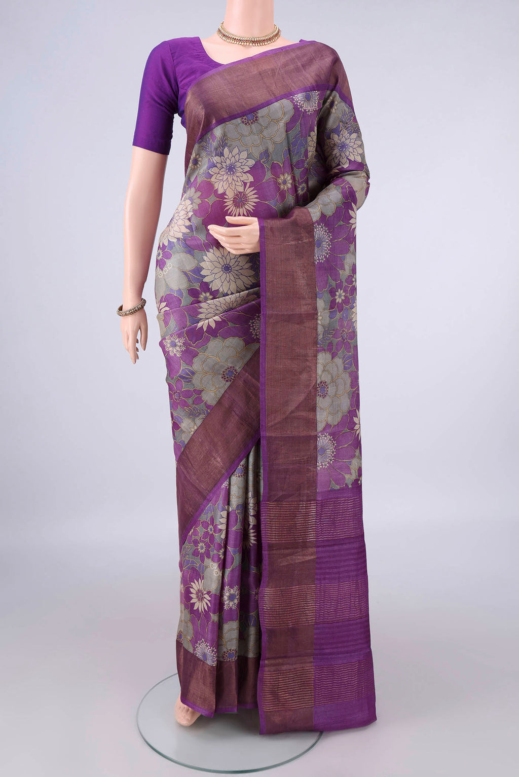 Purple Tussar Saree with Printed design on the body and Zari Border.  displayed on a mannequin