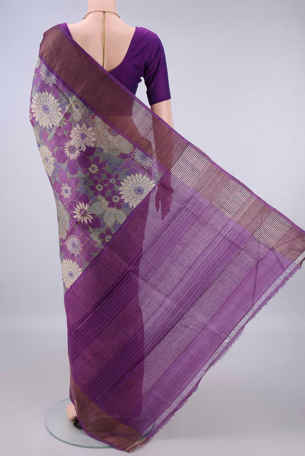 Flat view of Purple Tussar Saree with Printed design on the body and Zari Border. 