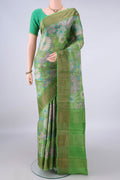 Green Tussar Saree with Floral Print on the body and Zari Border.  displayed on a mannequin