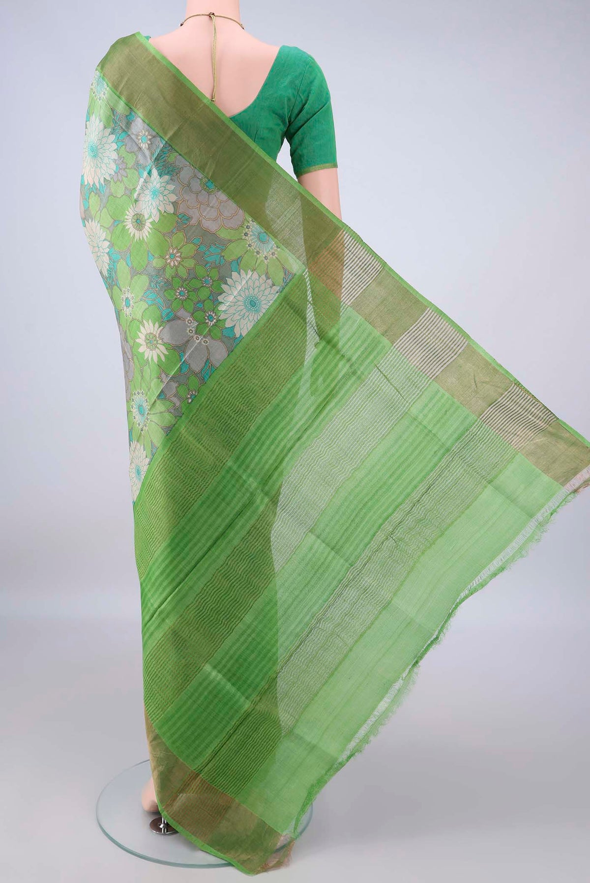 Flat view of Green Tussar Saree with Floral Print on the body and Zari Border. 