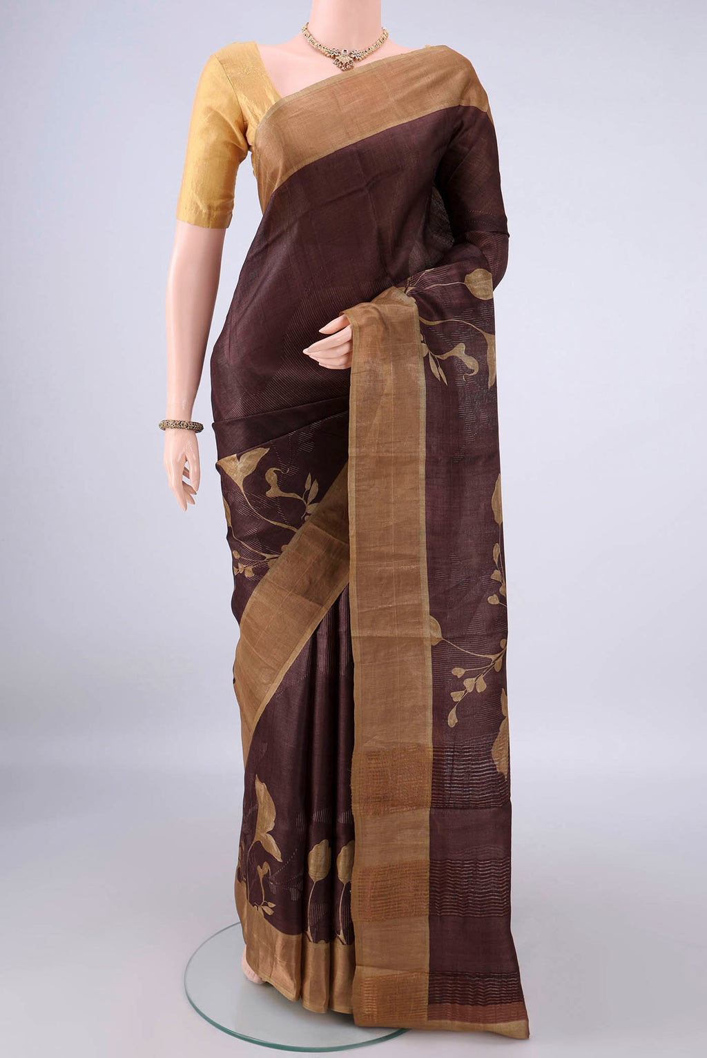Coffee Brown Tussar Saree with Printed design on the body and Zari Border.  displayed on a mannequin