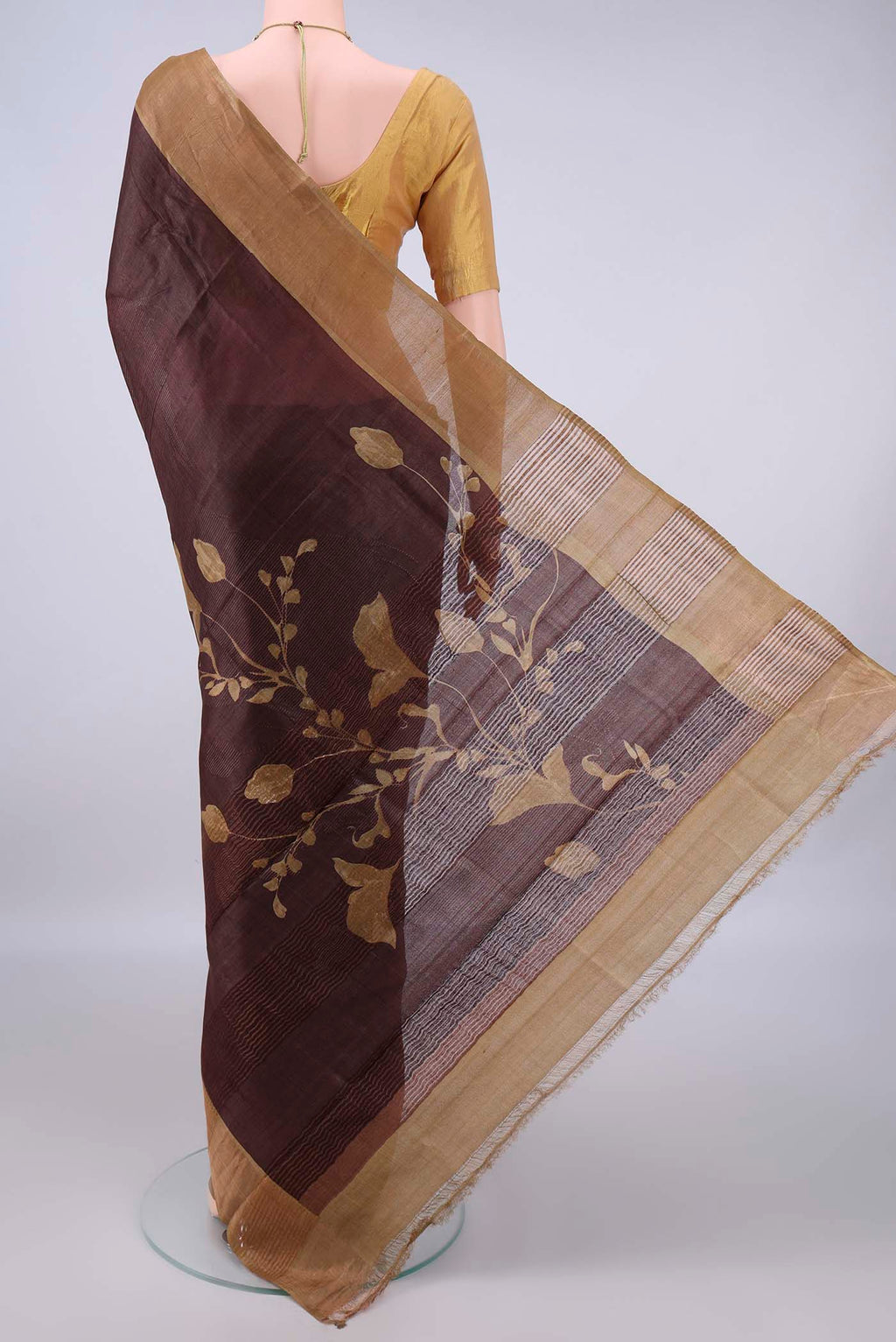 Flat view of Coffee Brown Tussar Saree with Printed design on the body and Zari Border. 