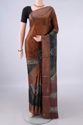 Bronze Tussar Saree with Printed design on the body and Zari Border.  displayed on a mannequin