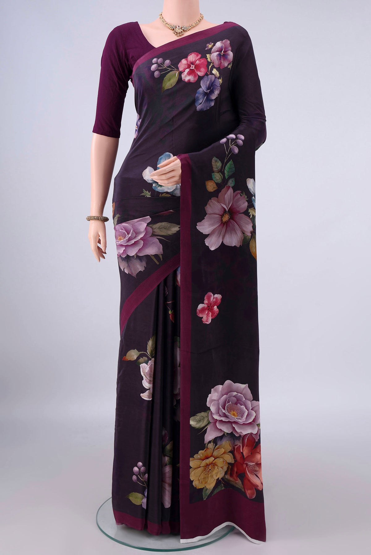 Burgundy Crepe Saree with Printed design on the body and Plain Border.  displayed on a mannequin