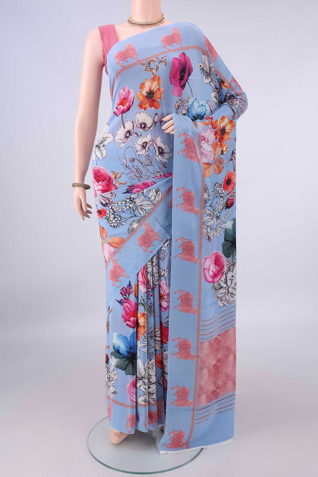 Sky Blue Crepe Saree with Printed design on the body and Printed Border.  displayed on a mannequin