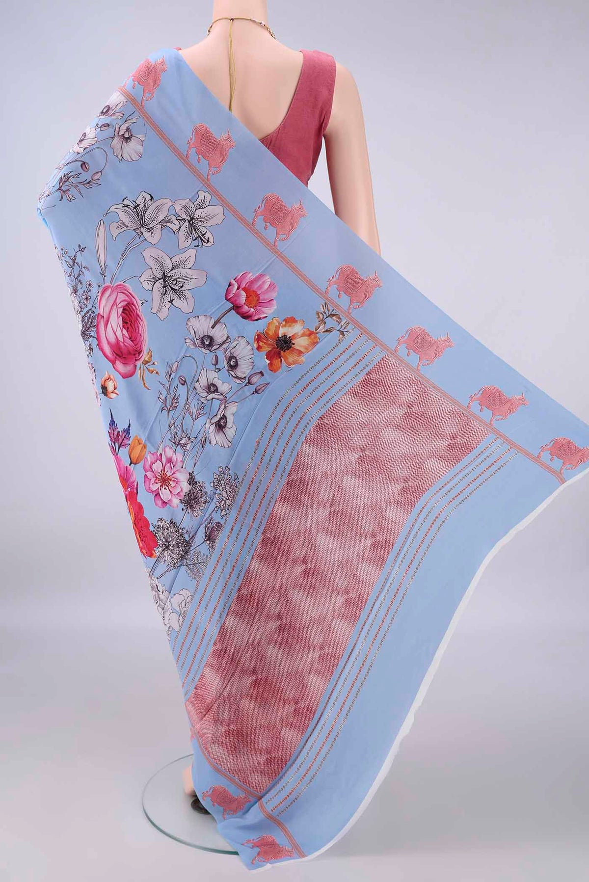Flat view of Sky Blue Crepe Saree with Printed design on the body and Printed Border. 