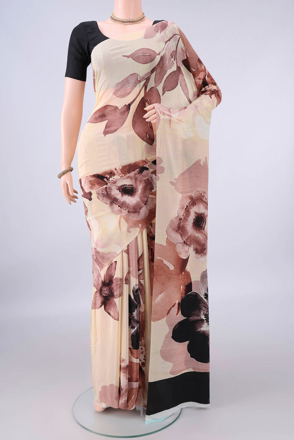Sandal Crepe Saree with Printed design on the body and Without Border.  displayed on a mannequin