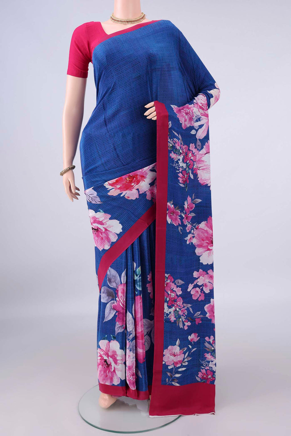 Royal Blue Crepe Saree with Printed design on the body and Plain Border.  displayed on a mannequin