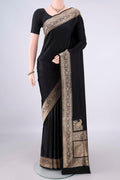 Black Banarasi Saree with Plain Body and Zari Border.  displayed on a mannequin