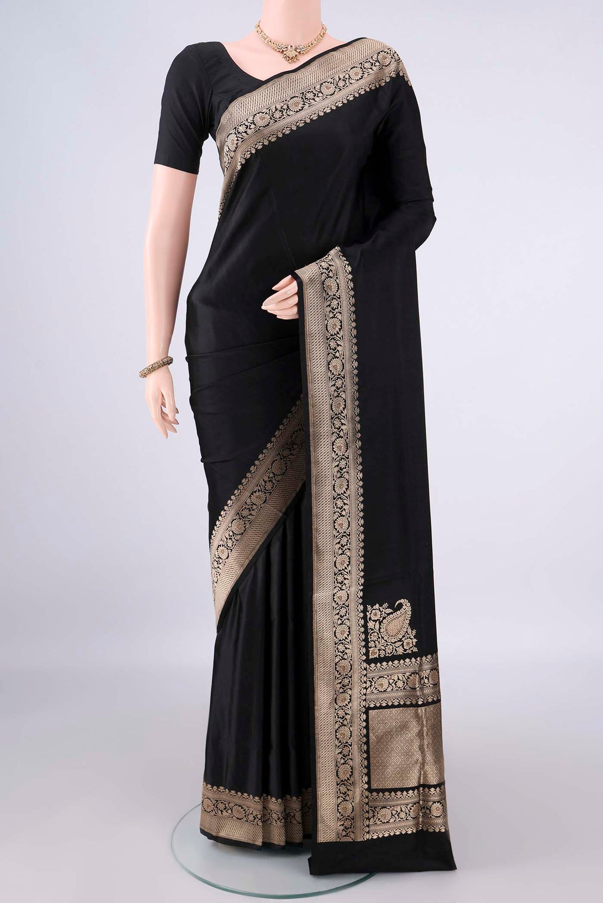 Black Banarasi Saree with Plain Body and Zari Border.  displayed on a mannequin