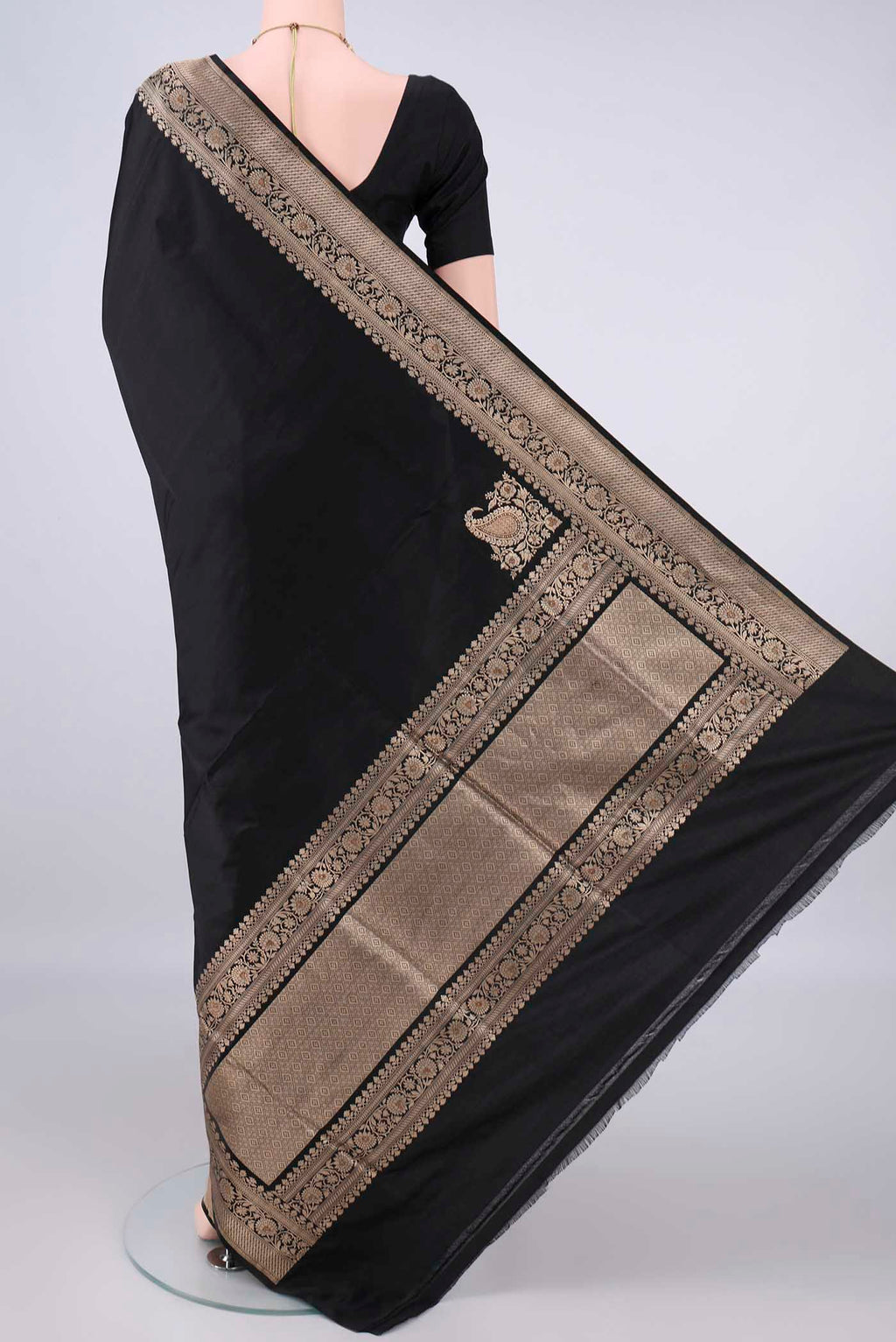 Flat view of Black Banarasi Saree with Plain Body and Zari Border. 