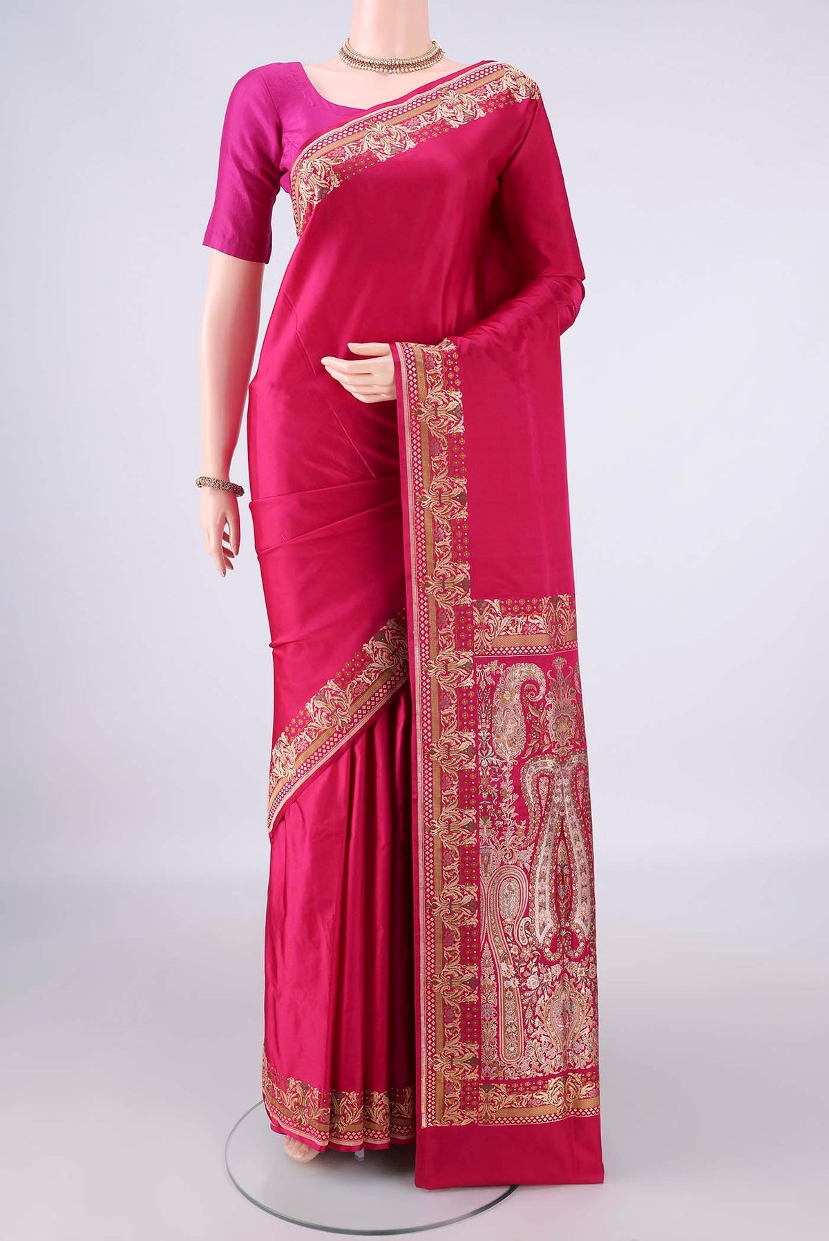 Rani Pink Banarasi Jamavar Saree with Plain Body and Thread Border.  displayed on a mannequin