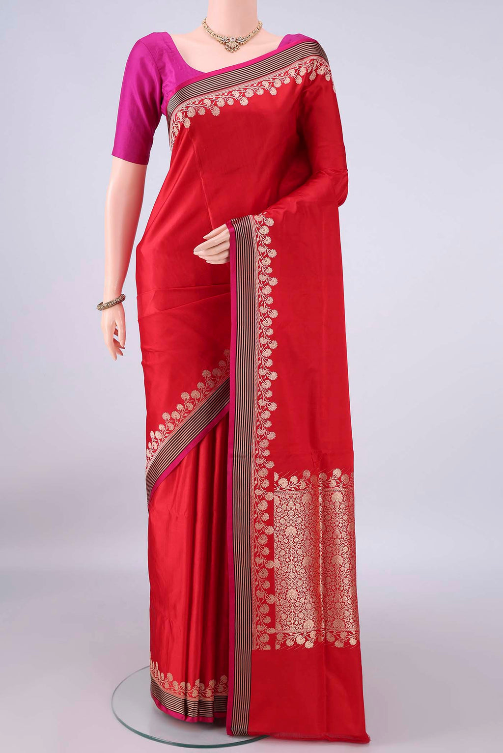 Red Banarasi Saree with Plain Body and Zari Border.  displayed on a mannequin