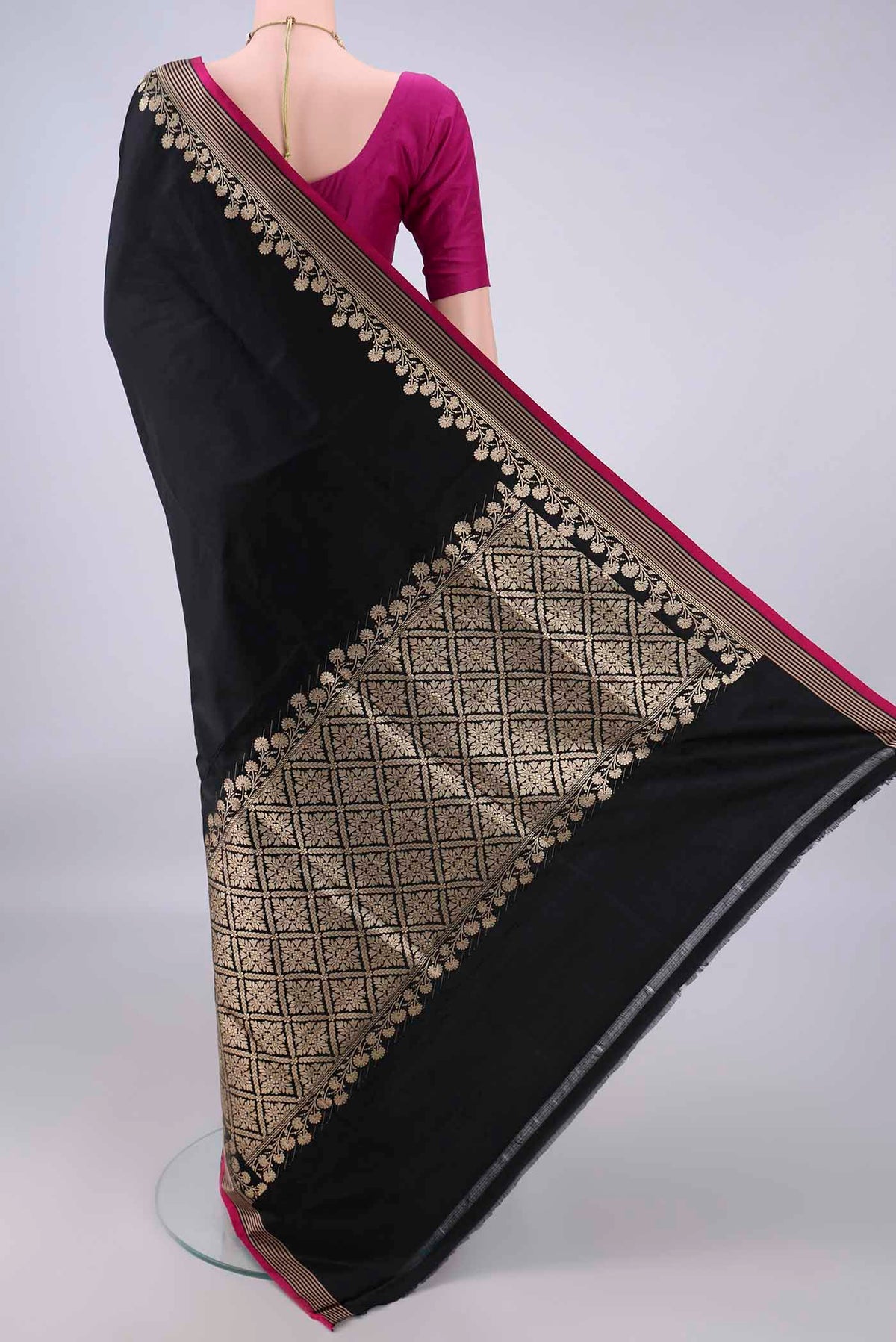 Flat view of Black Banarasi Saree with Plain Body and Zari Border. 
