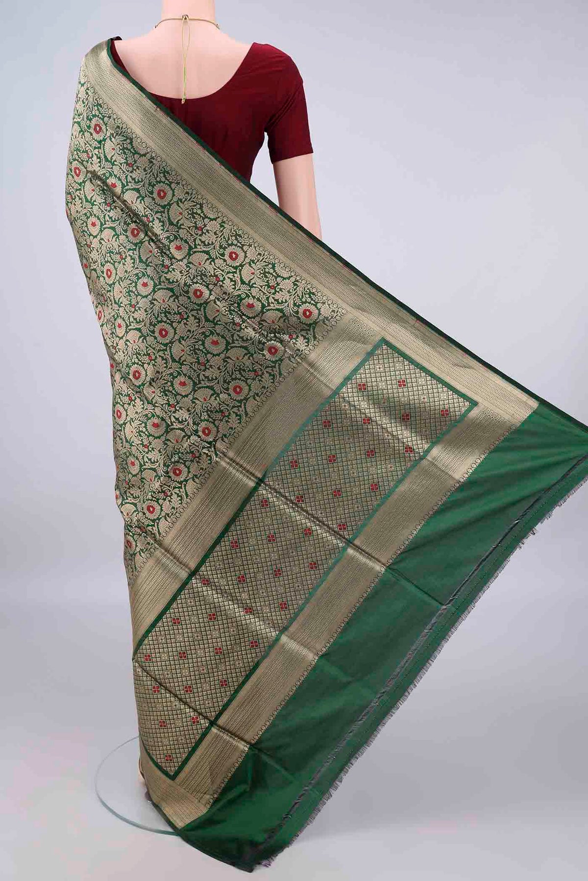 Flat view of Pure Silk Bottle Green Banarasi Saree with Zari Brocade on the body and Zari Border. 