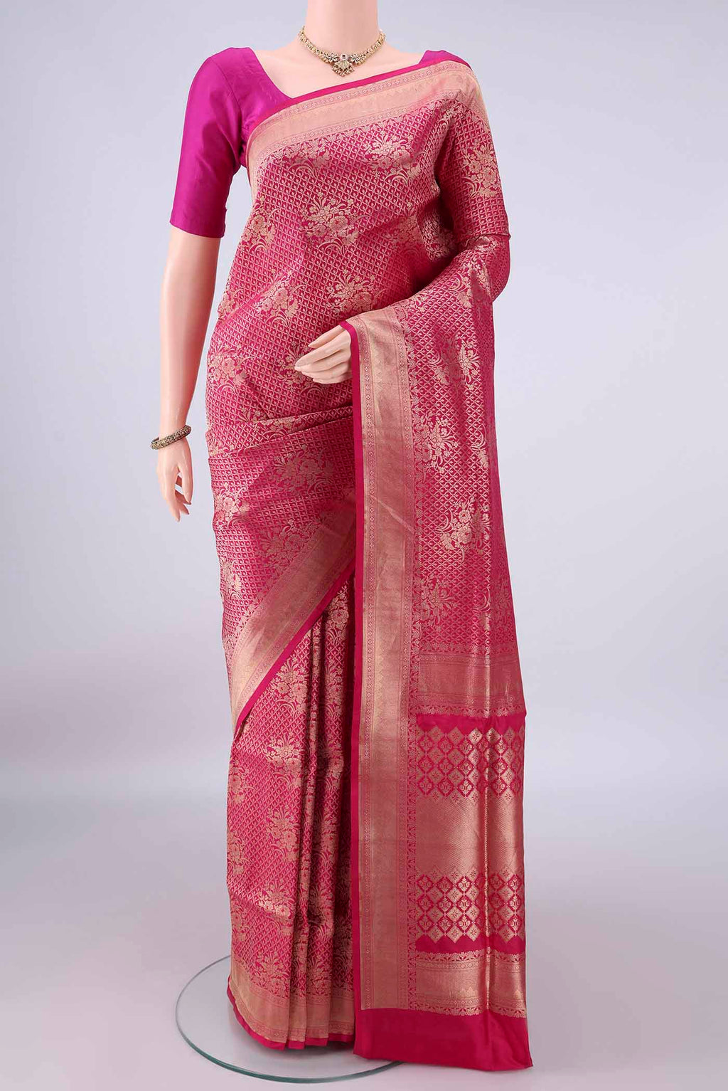 Pure Silk Rani Pink Banarasi Saree with Zari Brocade on the body and Zari Border.  displayed on a mannequin