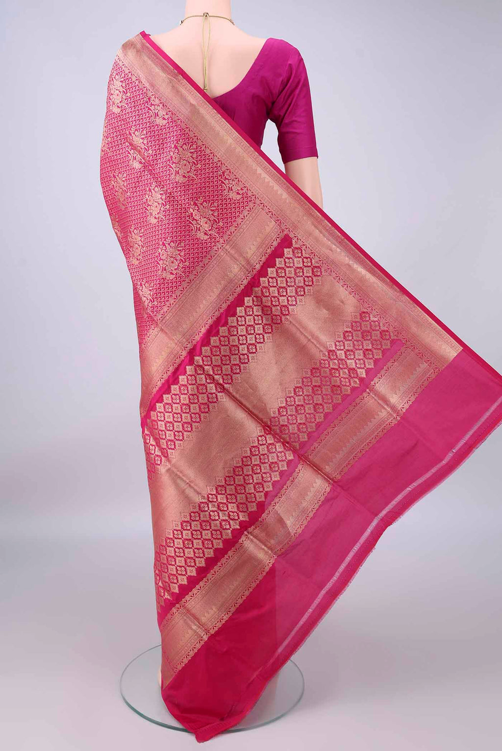 Flat view of Pure Silk Rani Pink Banarasi Saree with Zari Brocade on the body and Zari Border. 
