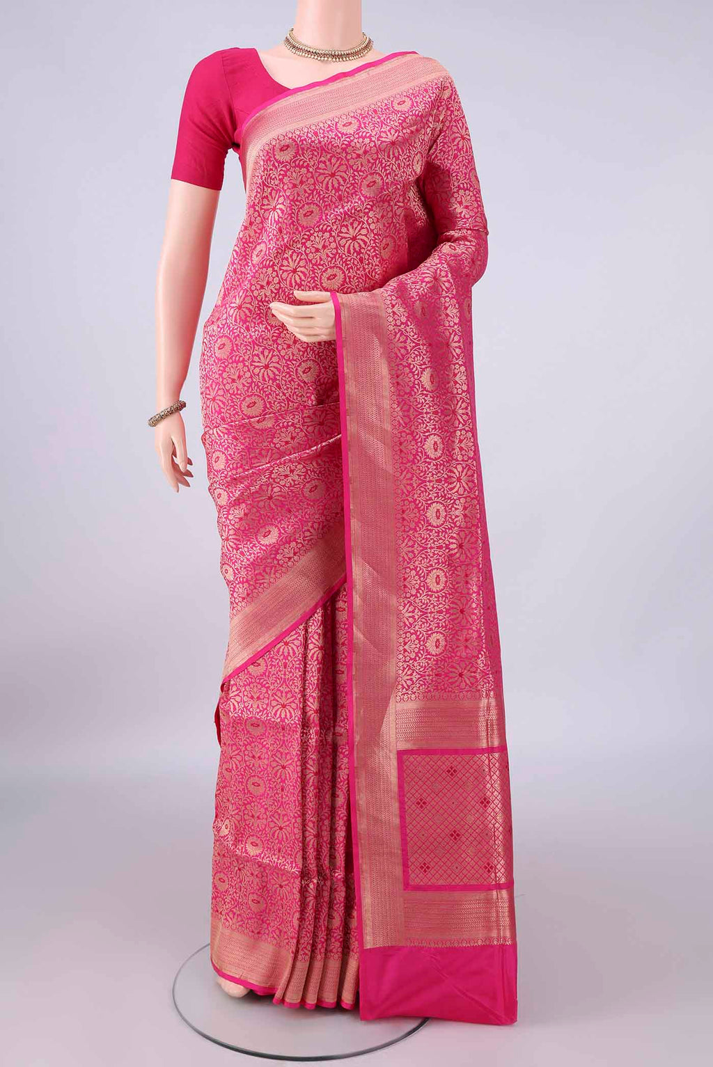 Pure Silk Rani Pink Banarasi Saree with Zari Brocade on the body and Zari Border.  displayed on a mannequin