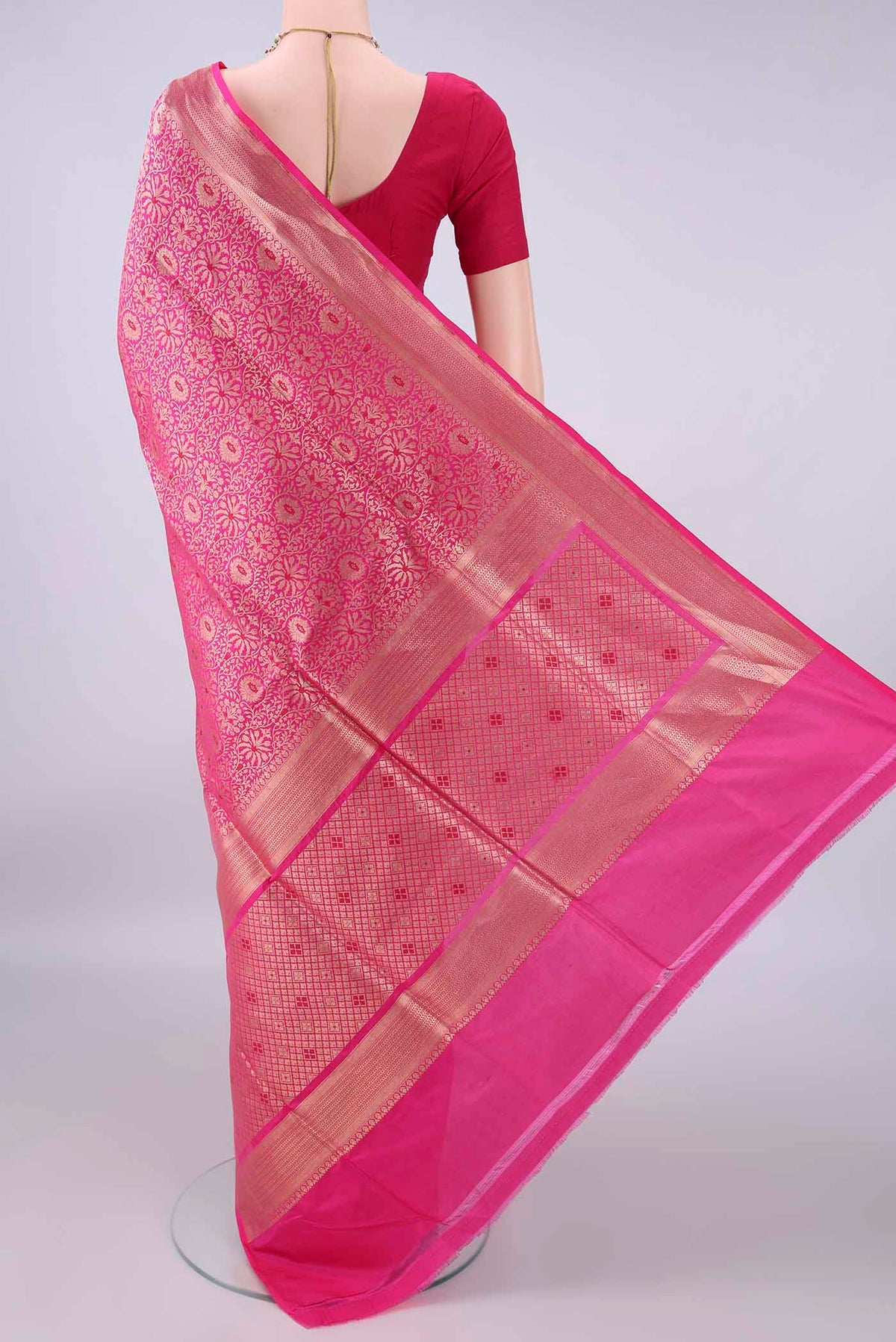Flat view of Pure Silk Rani Pink Banarasi Saree with Zari Brocade on the body and Zari Border. 
