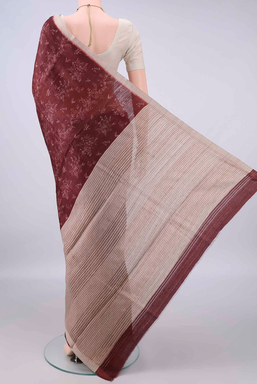 Flat view of Brown Tussar Saree with Printed design on the body and Zari Border. 