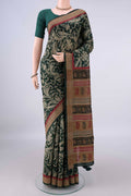 Bottle Green Tussar Saree with Printed design on the body and Zari Border.  displayed on a mannequin
