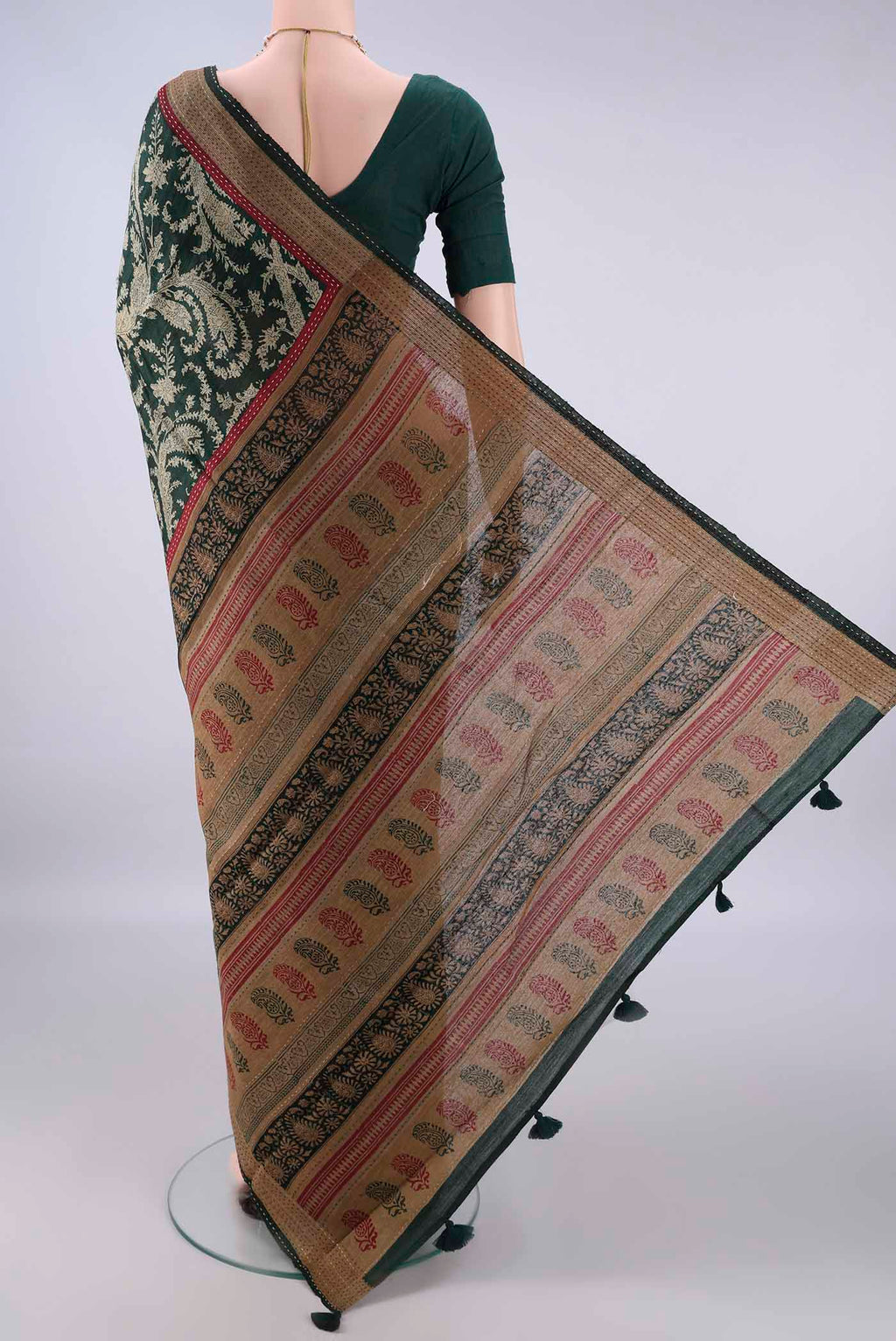 Flat view of Bottle Green Tussar Saree with Printed design on the body and Zari Border. 