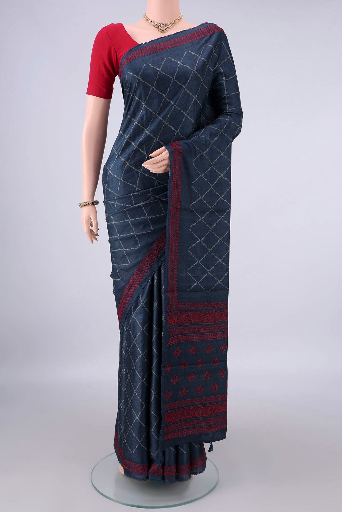 Blue Tussar Saree with Printed design on the body and Thread Border.  displayed on a mannequin