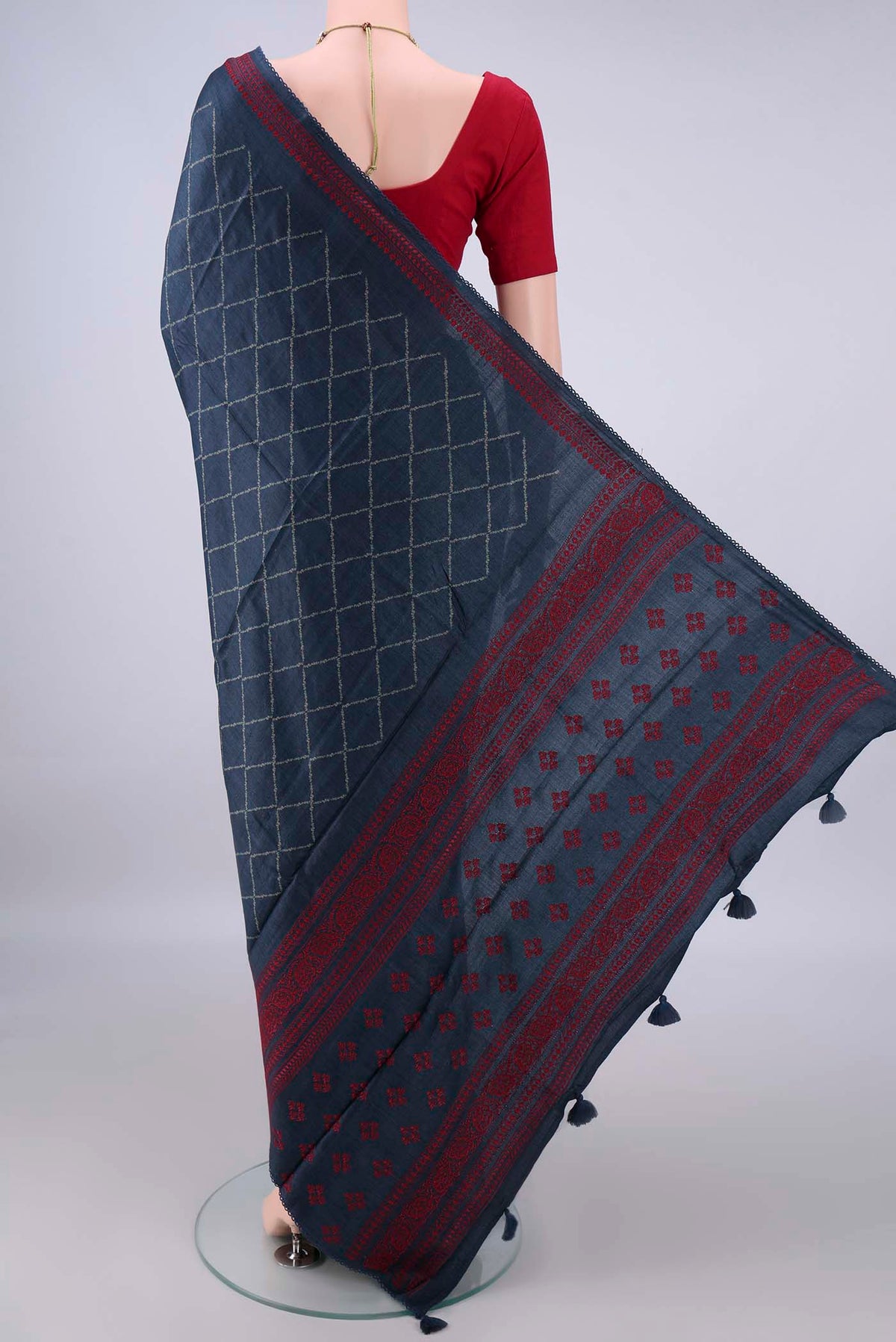 Flat view of Blue Tussar Saree with Printed design on the body and Thread Border. 