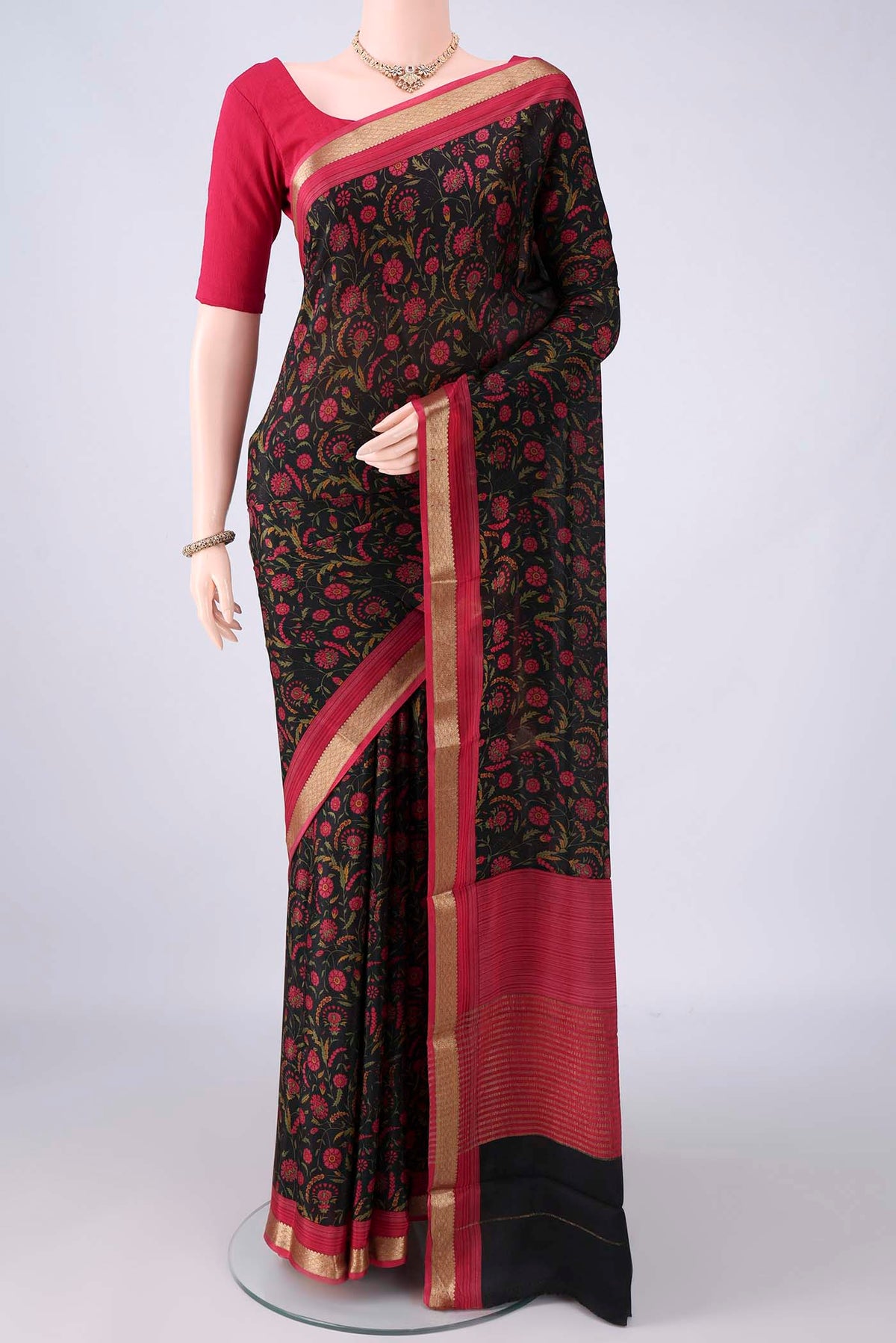 Black Mysore Crepe Saree with Printed design on the body and Zari Border.  displayed on a mannequin