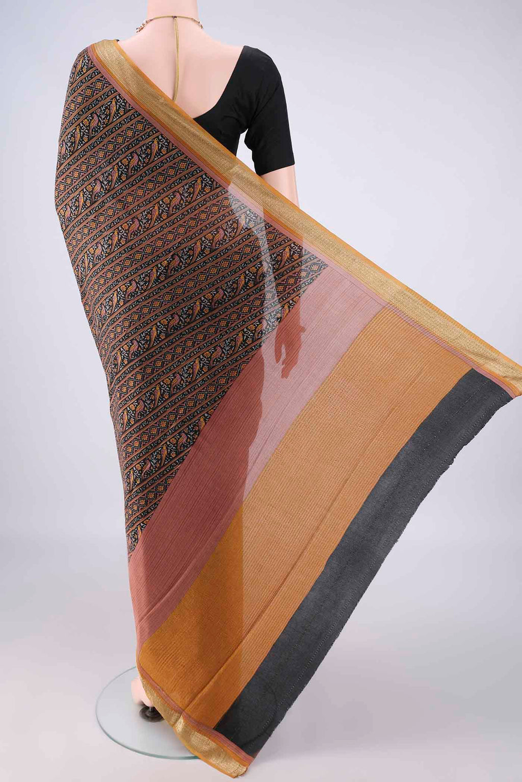Flat view of Black Mysore Crepe Saree with Printed design on the body and Zari Border. 