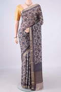 Beige Mysore Crepe Saree with Printed design on the body and Zari Border.  displayed on a mannequin