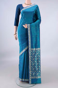 Pure Silk Peacock Blue Banarasi Katan Saree with Thread Butta on the body and Thread Border.  displayed on a mannequin