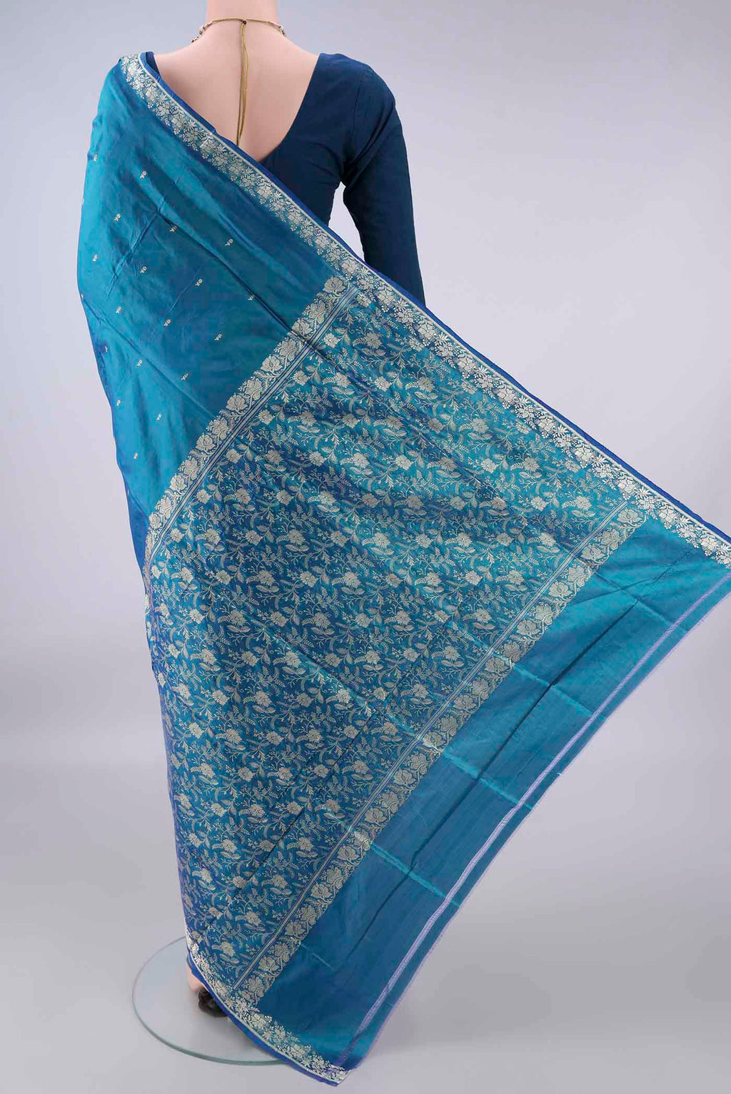 Flat view of Pure Silk Peacock Blue Banarasi Katan Saree with Thread Butta on the body and Thread Border. 