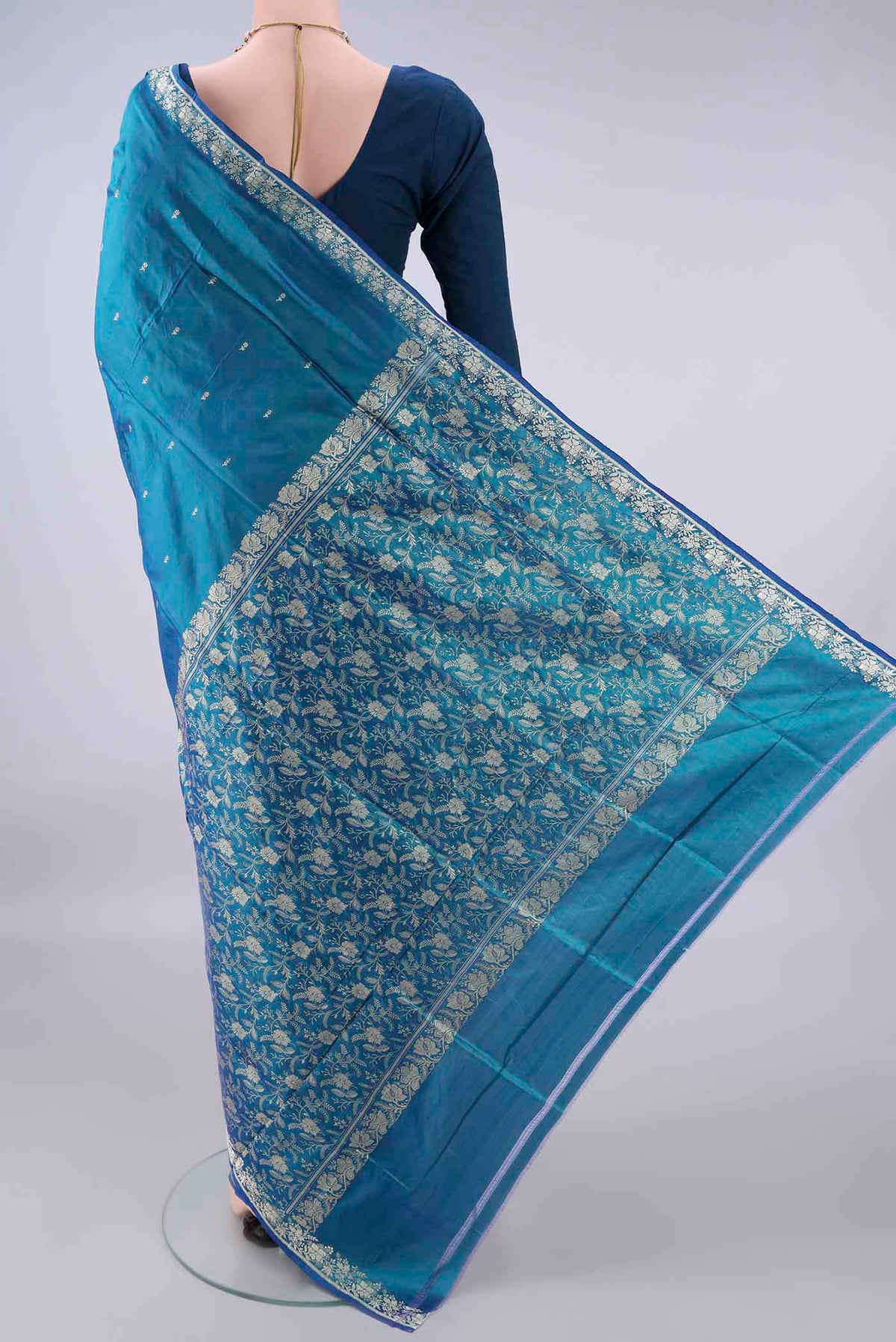 Flat view of Pure Silk Peacock Blue Banarasi Katan Saree with Thread Butta on the body and Thread Border. 