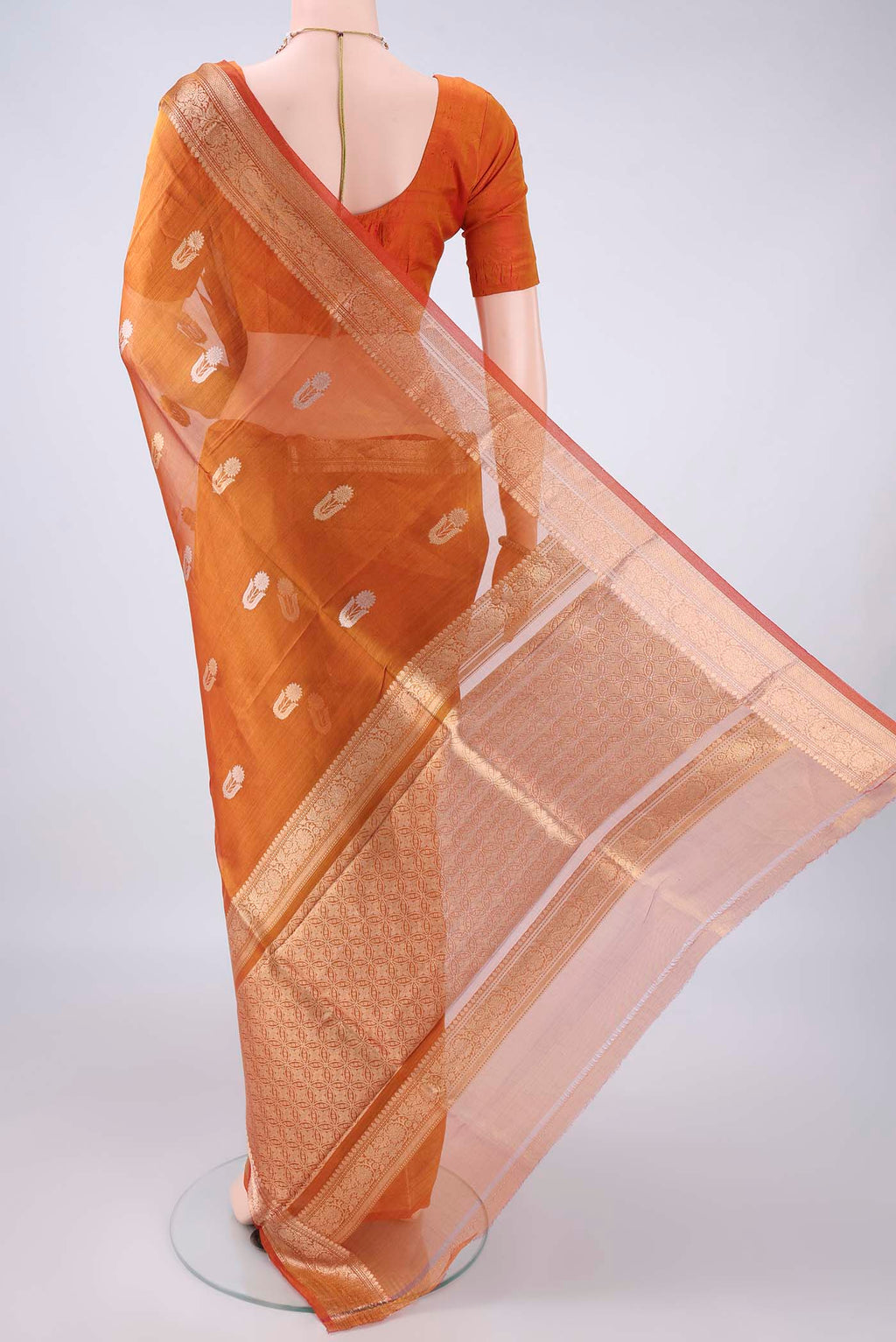 Flat view of Rust Dual Tone Organza Saree with Zari Butta on the body and Zari Border. 