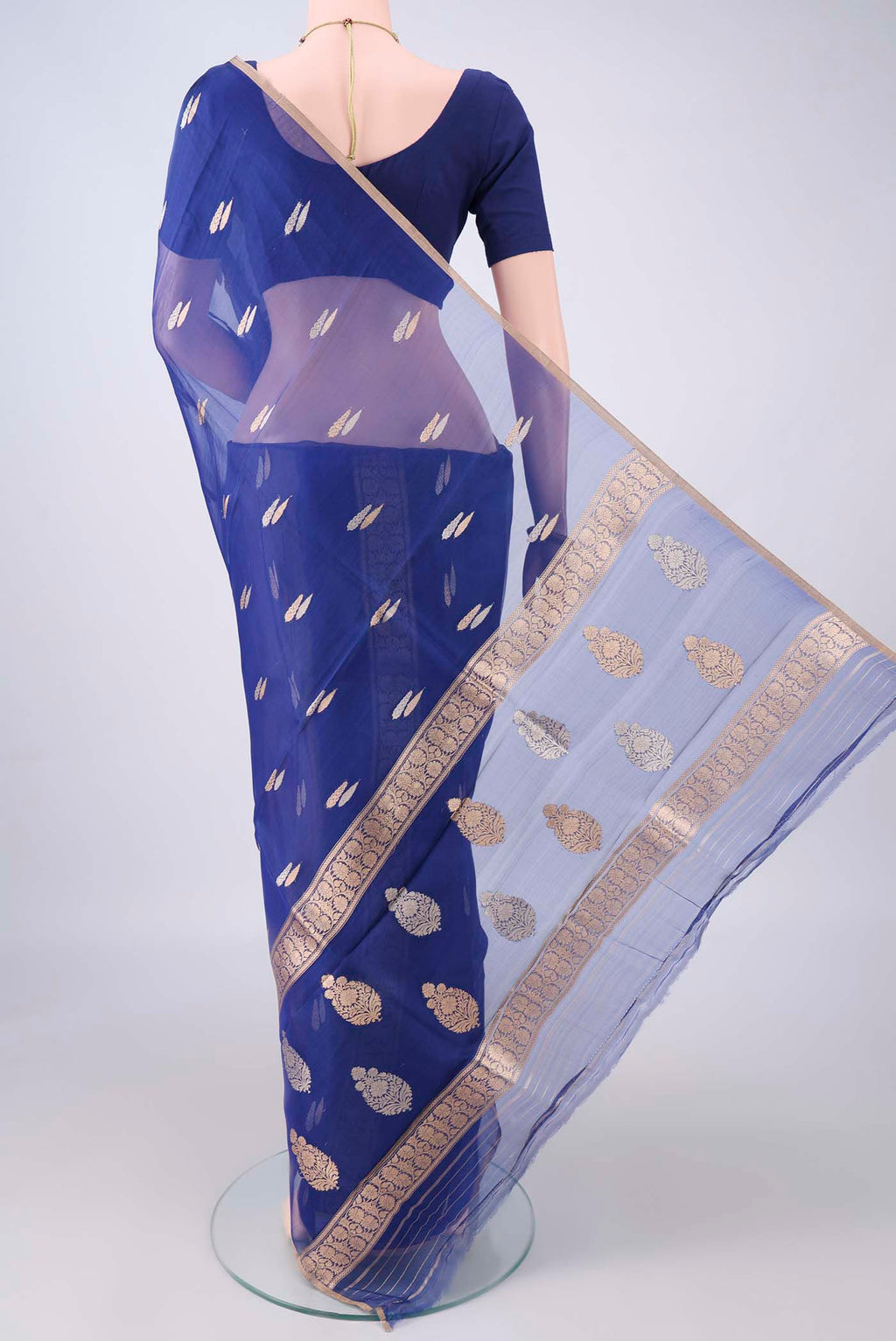Flat view of Royal Blue Organza Saree with Zari Butta on the body and Thin Zari Line. 