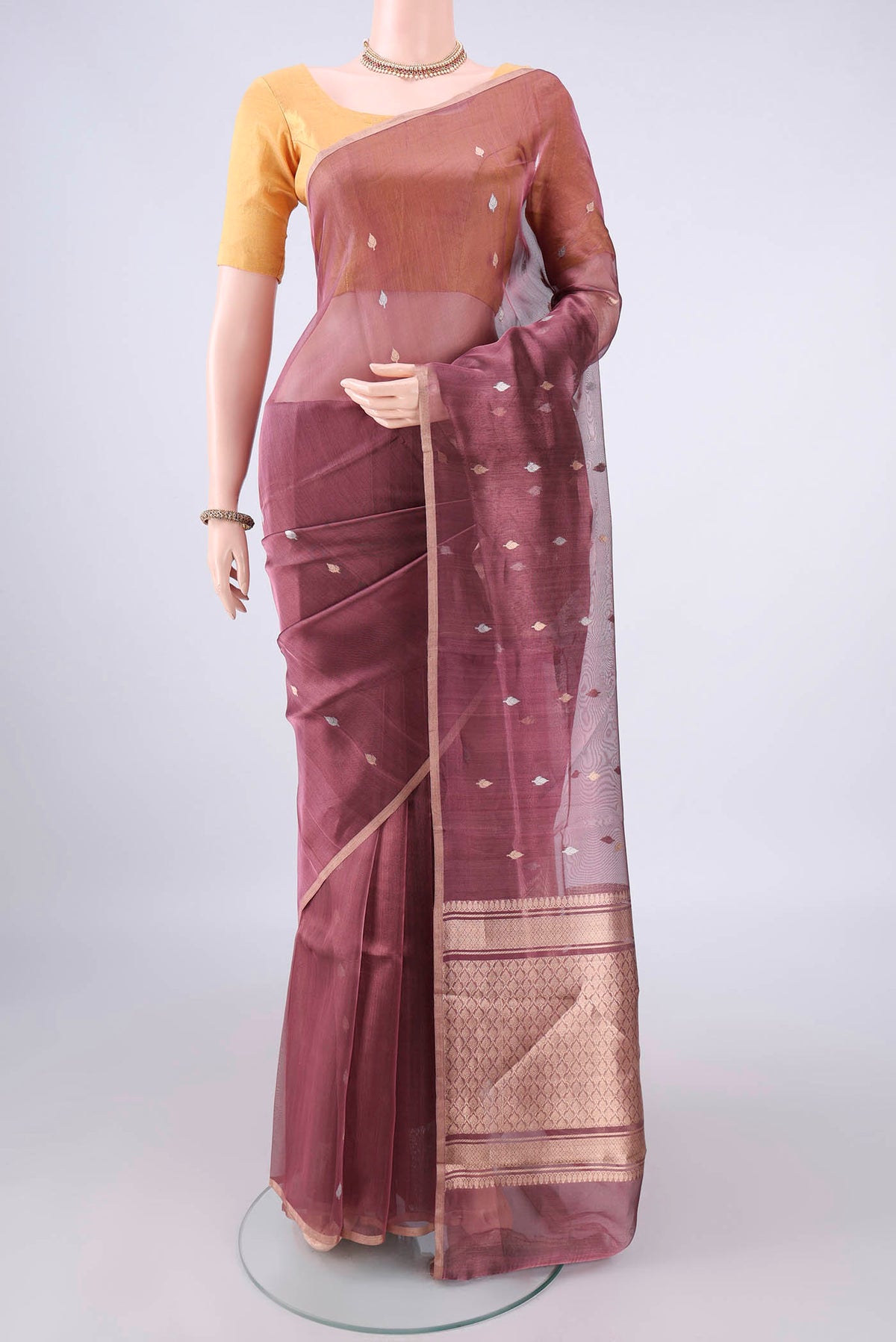 Mauve Dual Tone Organza Saree with Zari Butta on the body and Thin Zari Line.  displayed on a mannequin