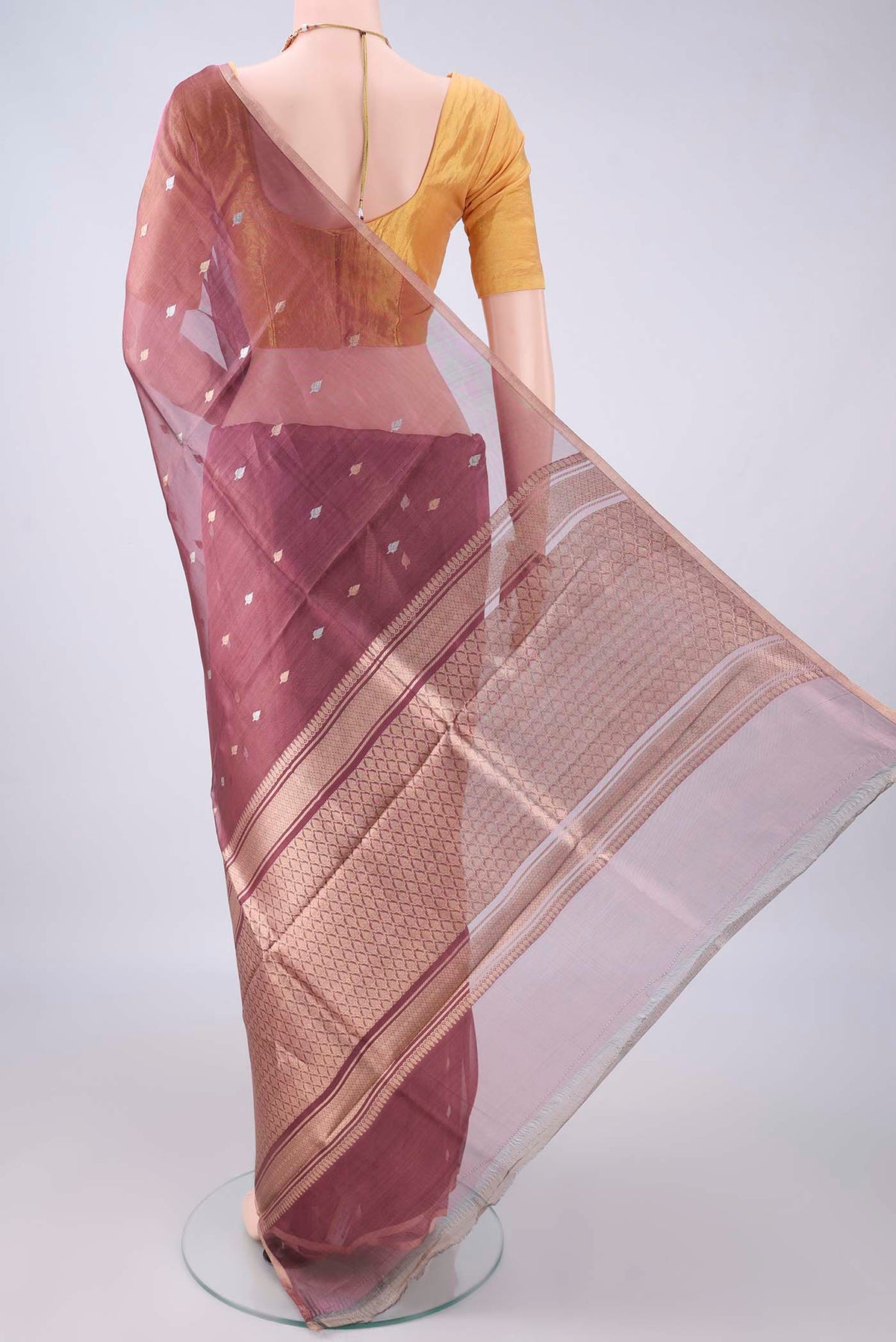 Flat view of Mauve Dual Tone Organza Saree with Zari Butta on the body and Thin Zari Line. 